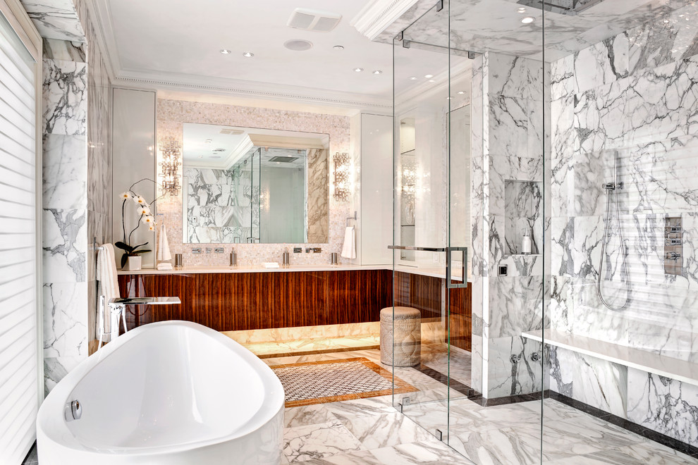 Inspiration for a large transitional master bathroom in Vancouver with flat-panel cabinets, medium wood cabinets, a freestanding tub, an alcove shower, gray tile, stone slab, grey walls and marble floors.