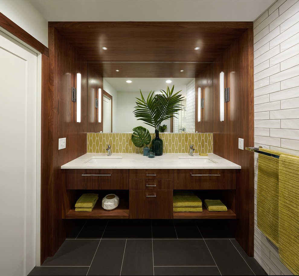 Inspiration for a mid-sized midcentury master bathroom in Minneapolis with flat-panel cabinets, medium wood cabinets, a curbless shower, a two-piece toilet, yellow tile, ceramic tile, white walls, ceramic floors, an undermount sink, engineered quartz benchtops, grey floor, a hinged shower door and white benchtops.
