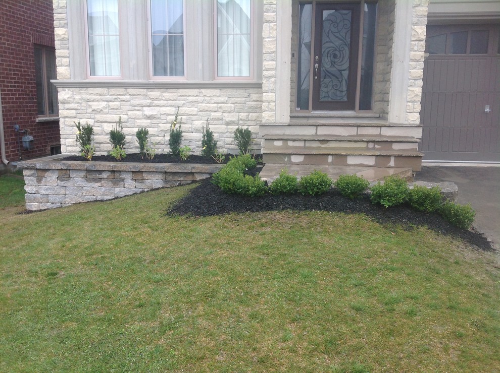 Photo of a mid-sized rustic partial sun backyard stone formal garden in Toronto for summer.