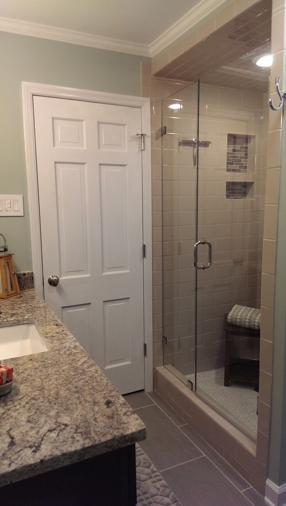 Design ideas for a mid-sized transitional bathroom in Atlanta with an undermount sink, raised-panel cabinets, medium wood cabinets, granite benchtops, an alcove shower, a two-piece toilet, beige tile, ceramic tile, grey walls and porcelain floors.