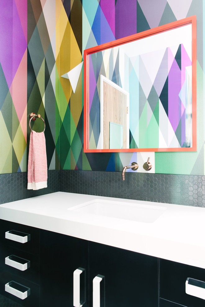 This is an example of a contemporary bathroom in Los Angeles with an integrated sink, black cabinets, multi-coloured walls and flat-panel cabinets.