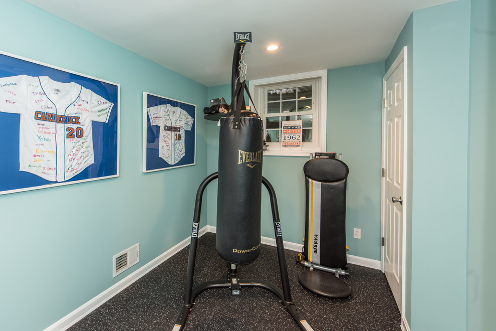 This is an example of a small traditional multipurpose gym in DC Metro with blue walls and black floor.
