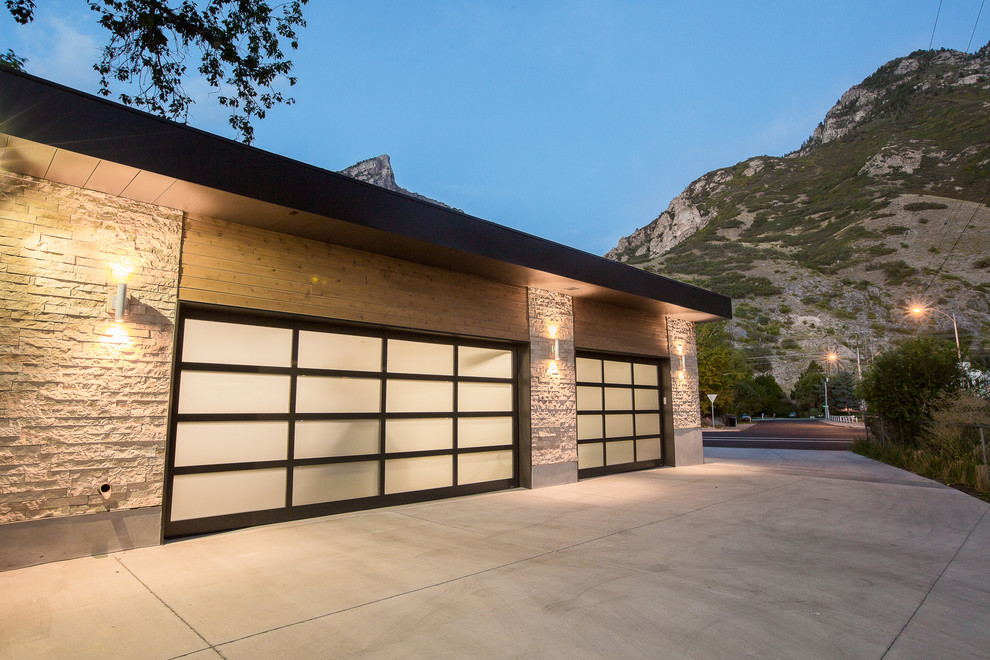 This is an example of a mid-sized midcentury attached three-car garage in Salt Lake City.