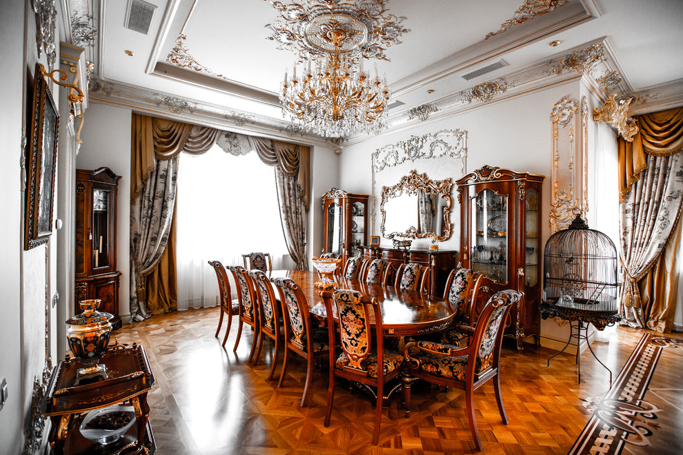 This is an example of a traditional open plan dining in Moscow with white walls, medium hardwood floors and brown floor.
