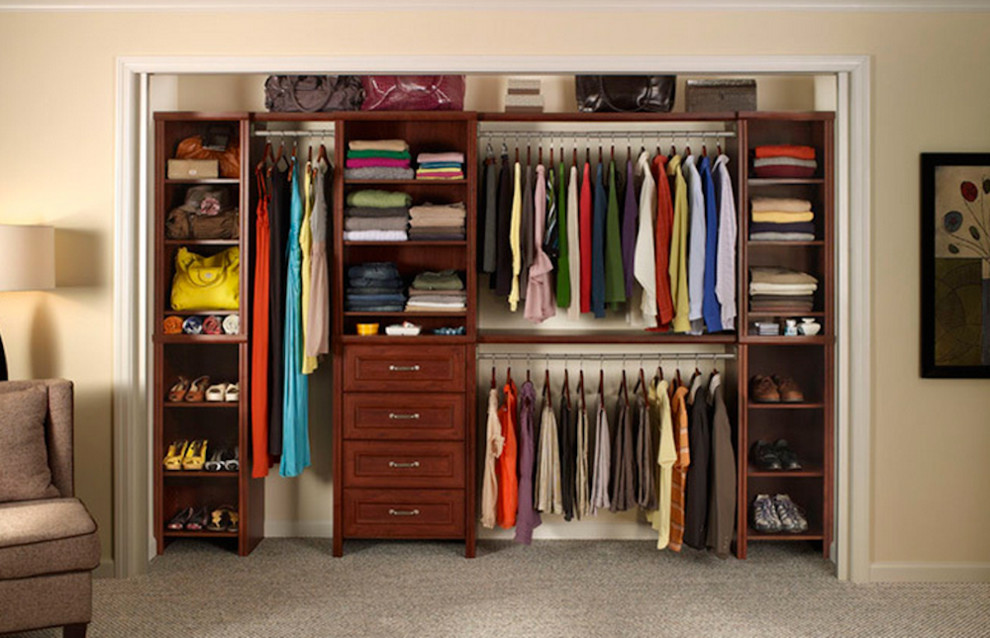 This is an example of a mid-sized storage and wardrobe in New York with carpet.