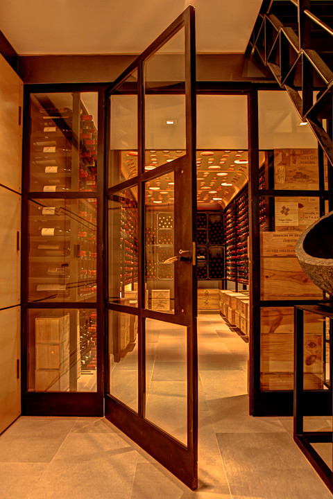 Design ideas for a large contemporary wine cellar in New York with storage racks and limestone floors.