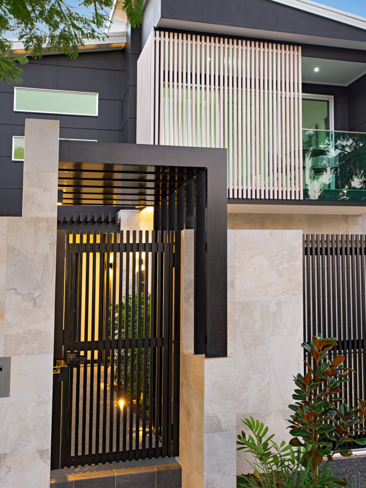 Design ideas for a mid-sized modern two-storey grey house exterior in Brisbane.