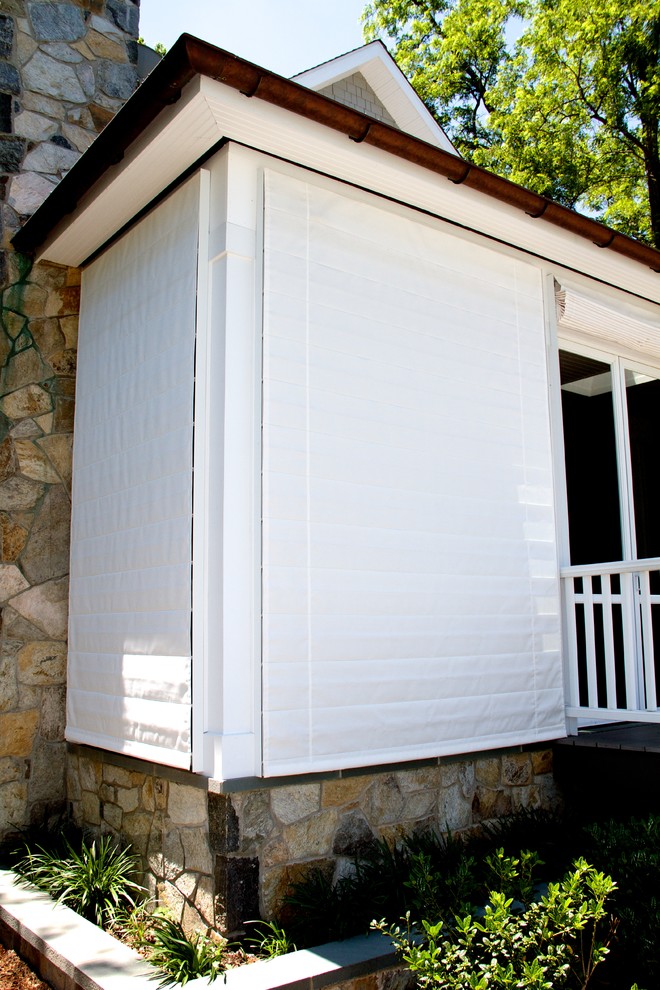 Outdoor shades protect screen porch.