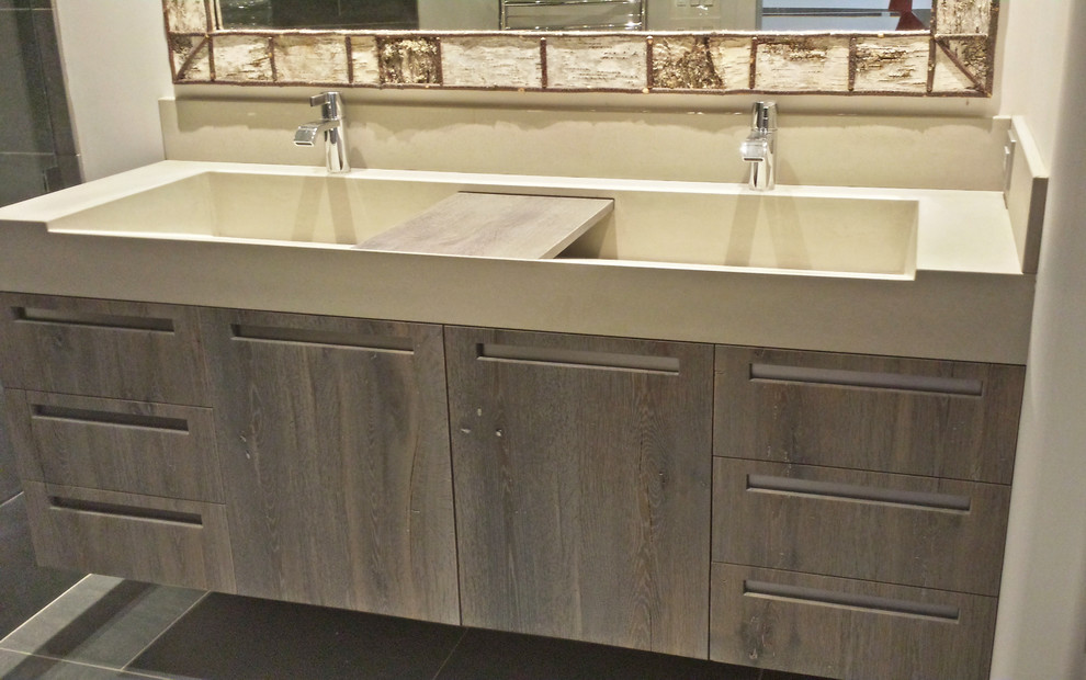 Mid-sized transitional gray tile and ceramic tile bathroom photo with an integrated sink, flat-panel cabinets, dark wood cabinets, concrete countertops, an undermount tub and white walls