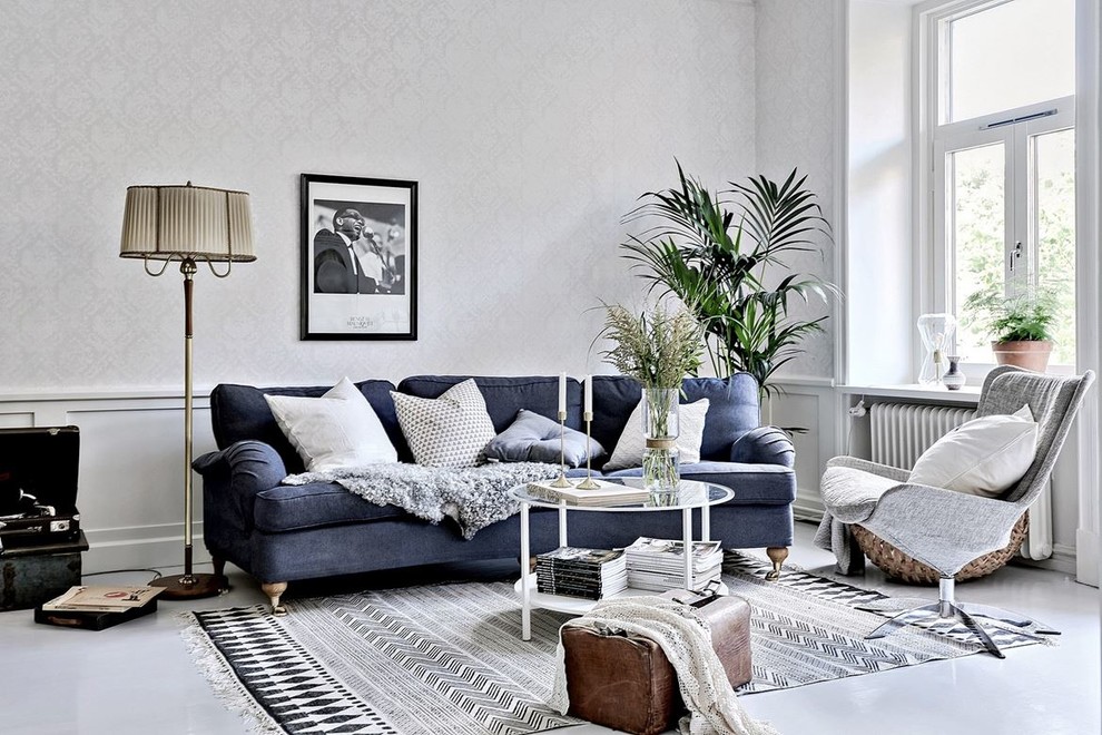 This is an example of a mid-sized scandinavian formal open concept living room in Gothenburg with grey walls, concrete floors and no tv.