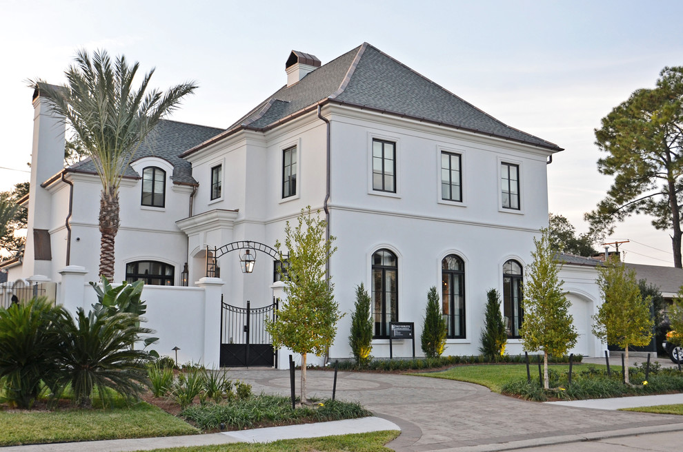 Design ideas for a large traditional two-storey stucco white exterior in New Orleans.