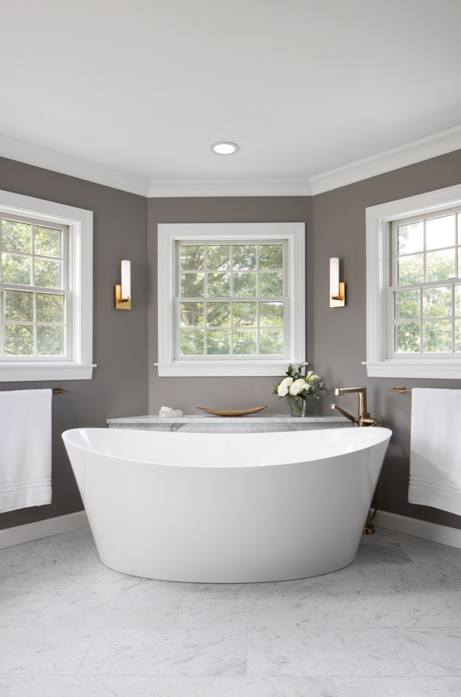 This is an example of an expansive transitional master bathroom in Other with recessed-panel cabinets, dark wood cabinets, a freestanding tub, a two-piece toilet, gray tile, marble, grey walls, marble floors, an undermount sink, granite benchtops, grey floor, a sliding shower screen, white benchtops, an enclosed toilet, a single vanity and a freestanding vanity.