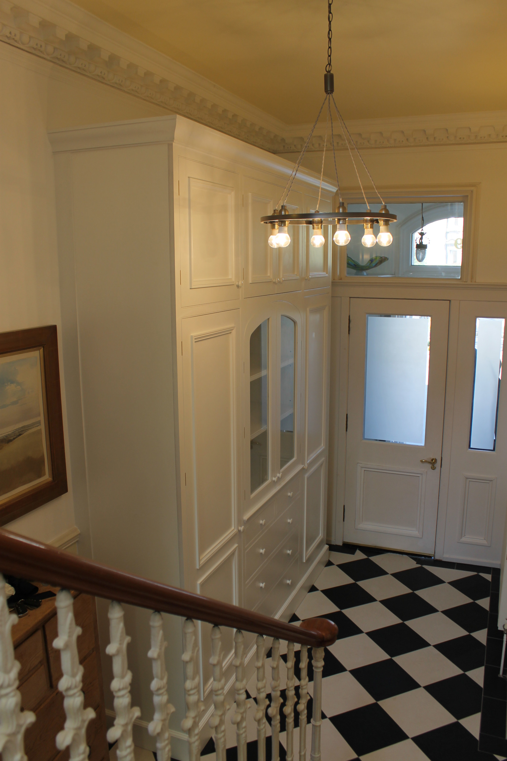 Hallway cabinet with three center arched glazed doors