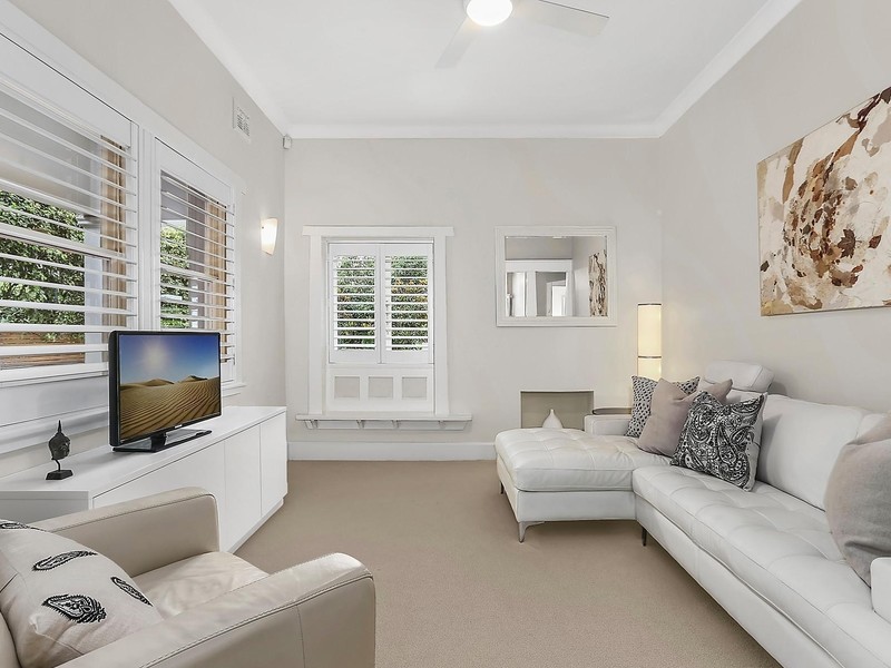 This is an example of a large contemporary formal open concept living room in Sydney with white walls, carpet and a wall-mounted tv.