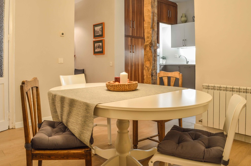 Imagen de comedor tradicional renovado de tamaño medio abierto con paredes beige y suelo de madera clara