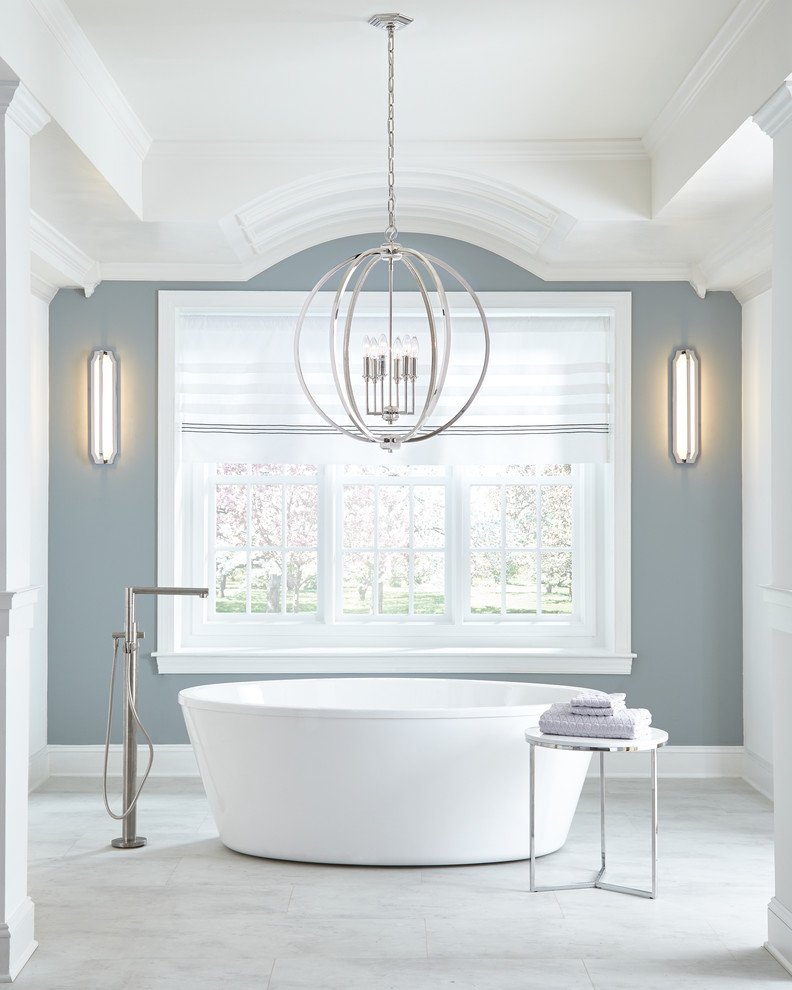 This is an example of a large transitional master bathroom in Charlotte with a freestanding tub, blue walls and white floor.