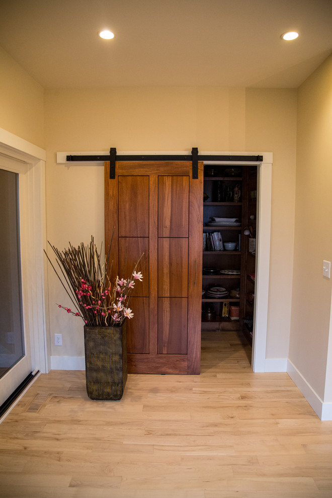 Inspiration for a transitional light wood floor and brown floor hallway remodel in Minneapolis with beige walls