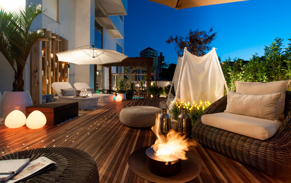 This is an example of an expansive industrial rooftop and rooftop deck in Miami with a fire feature.
