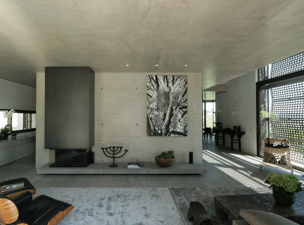 Inspiration for a large contemporary open concept family room in Stuttgart with grey walls, concrete floors and a standard fireplace.