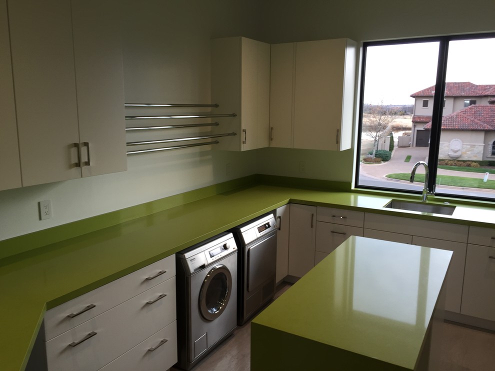 Photo of a large contemporary u-shaped utility room in Oklahoma City with an undermount sink, flat-panel cabinets, white cabinets, quartz benchtops, white walls, ceramic floors, a side-by-side washer and dryer, grey floor and green benchtop.