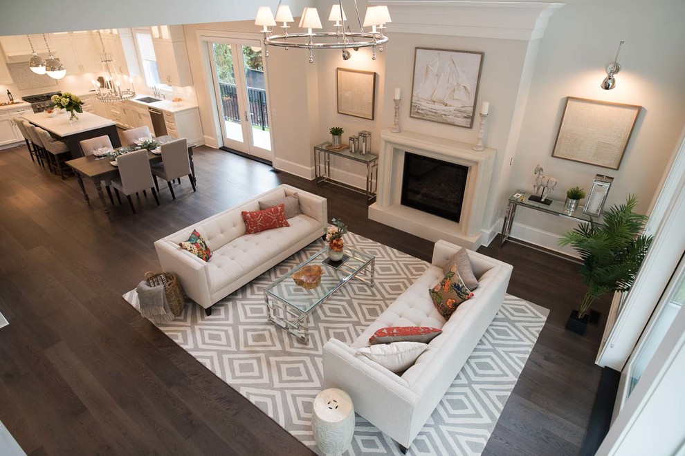Photo of a large transitional formal open concept living room in Vancouver with beige walls, dark hardwood floors, a standard fireplace, a stone fireplace surround, no tv and brown floor.