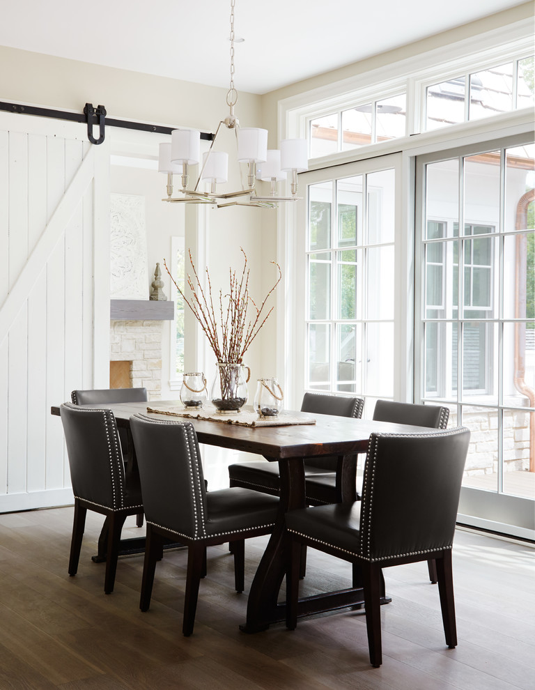 Inspiration for a transitional dining room in Chicago with beige walls and dark hardwood floors.