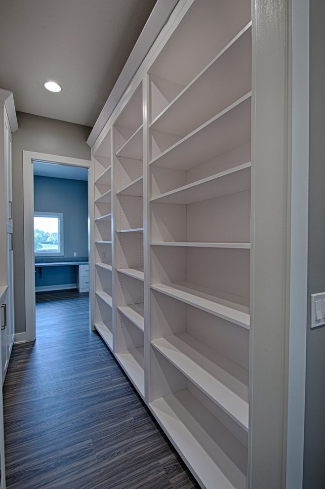 Example of a large transitional galley vinyl floor and gray floor home design design with a single-bowl sink, shaker cabinets, white cabinets, quartzite countertops, gray backsplash, ceramic backsplash, stainless steel appliances and an island