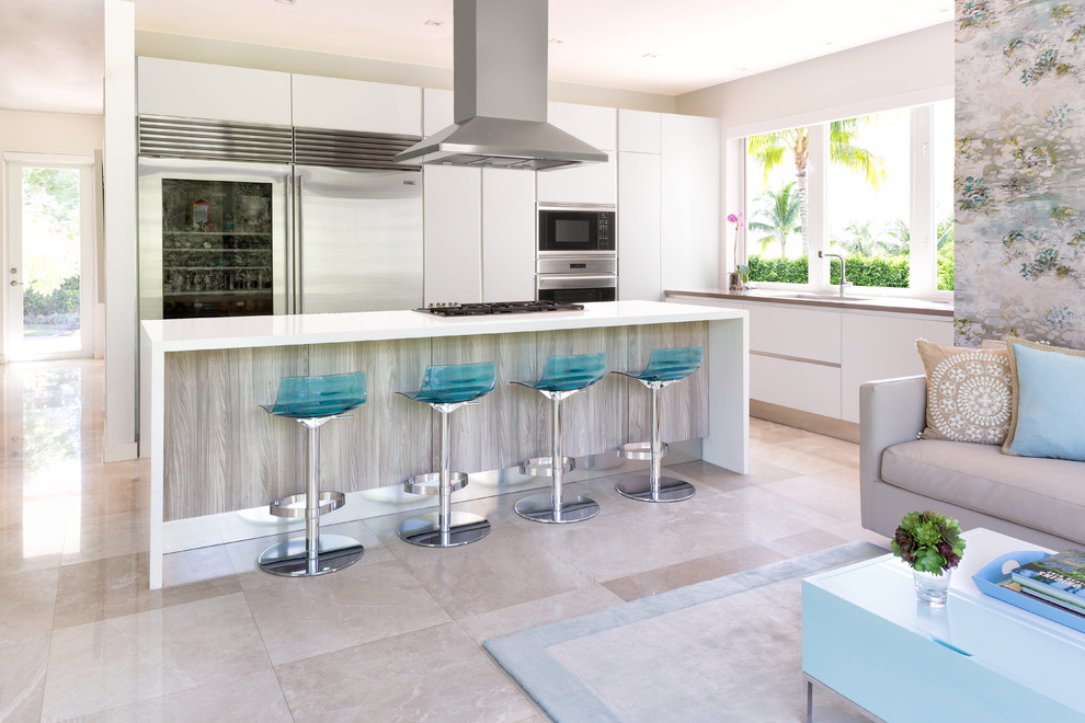 Design ideas for a large beach style l-shaped open plan kitchen in Miami with an undermount sink, flat-panel cabinets, white cabinets, quartz benchtops, stainless steel appliances, marble floors and with island.