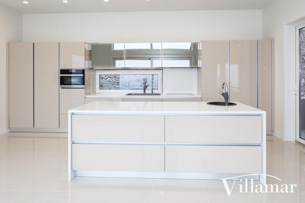 Inspiration for a large modern l-shaped open plan kitchen in Vancouver with a drop-in sink, flat-panel cabinets, beige cabinets, quartz benchtops, white splashback, window splashback, stainless steel appliances, porcelain floors and with island.