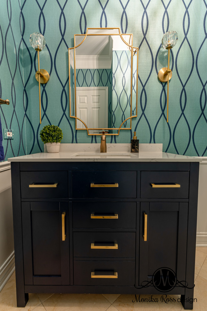 Photo of a medium sized traditional cloakroom in Chicago with shaker cabinets, blue cabinets, blue walls, limestone flooring, a submerged sink, marble worktops, beige floors, white worktops, a freestanding vanity unit and wallpapered walls.