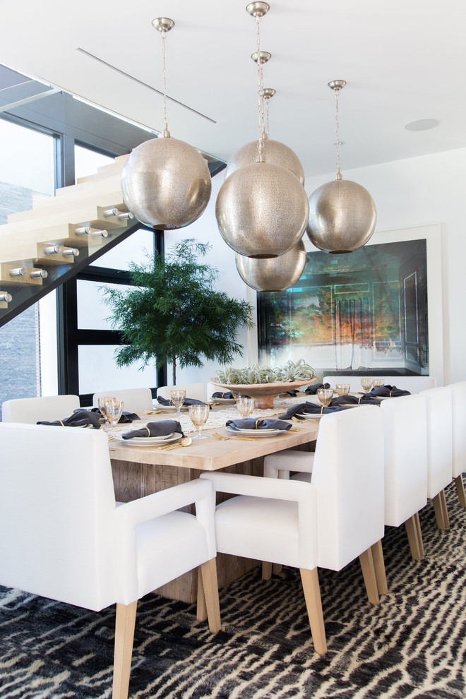 Inspiration for a large contemporary separate dining room in Los Angeles with white walls, limestone floors, a two-sided fireplace and a tile fireplace surround.