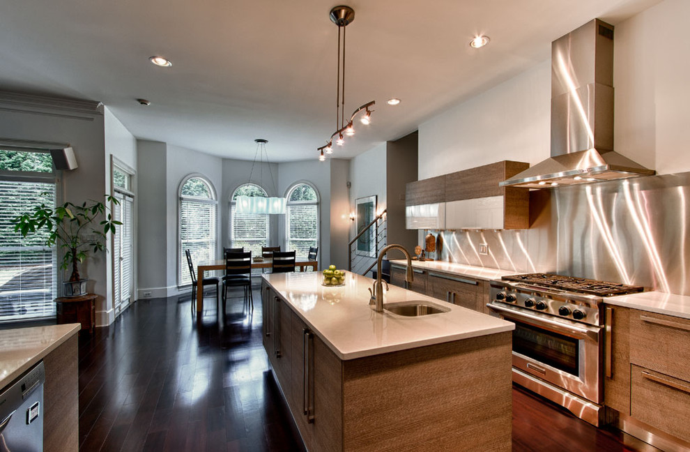 Mid-sized contemporary galley eat-in kitchen in Atlanta with a double-bowl sink, flat-panel cabinets, medium wood cabinets, quartz benchtops, metallic splashback, metal splashback, stainless steel appliances, dark hardwood floors and with island.