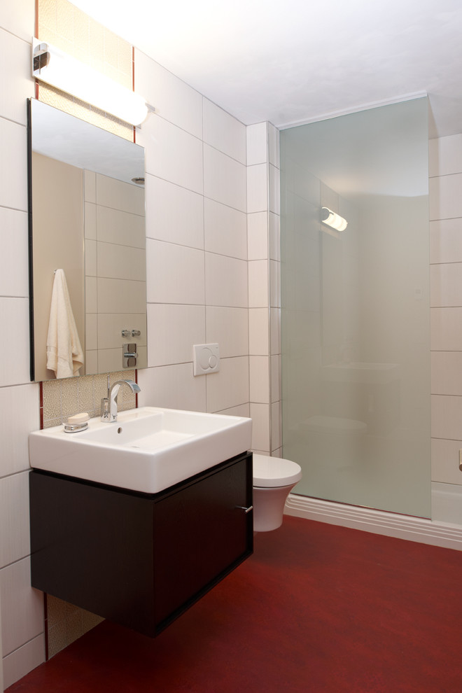 Photo of a small contemporary 3/4 bathroom in Minneapolis with flat-panel cabinets, dark wood cabinets, an alcove shower, a wall-mount toilet, white tile, ceramic tile, white walls, laminate floors, an integrated sink, quartzite benchtops, red floor and a hinged shower door.