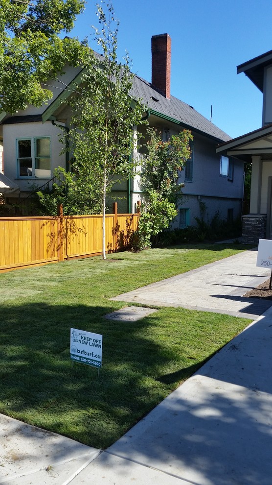 This is an example of a small rustic full sun front yard concrete paver driveway.