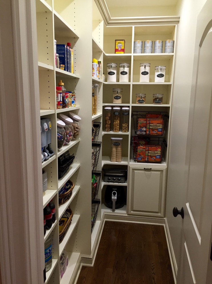 Design ideas for a mid-sized traditional l-shaped kitchen pantry in Cleveland with white cabinets, dark hardwood floors, no island, brown floor and open cabinets.