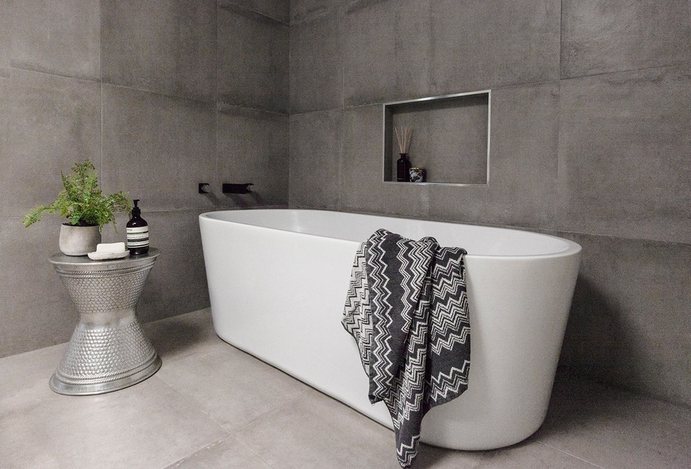 Design ideas for a large contemporary master bathroom in Geelong with a freestanding tub, grey walls, cement tiles, grey floor, flat-panel cabinets, medium wood cabinets, an open shower, gray tile, cement tile, a vessel sink, engineered quartz benchtops, an open shower and white benchtops.