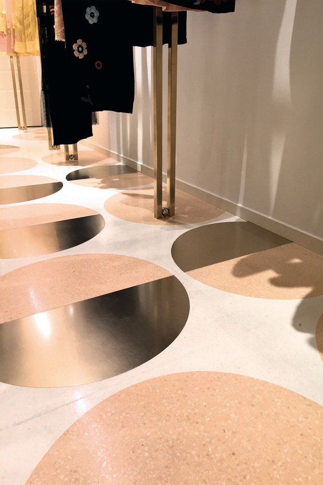 Large minimalist terrazzo floor and gray floor hallway photo in Los Angeles with gray walls