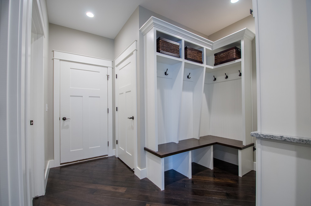 Inspiration for a mid-sized transitional dark wood floor mudroom remodel with gray walls and a white front door