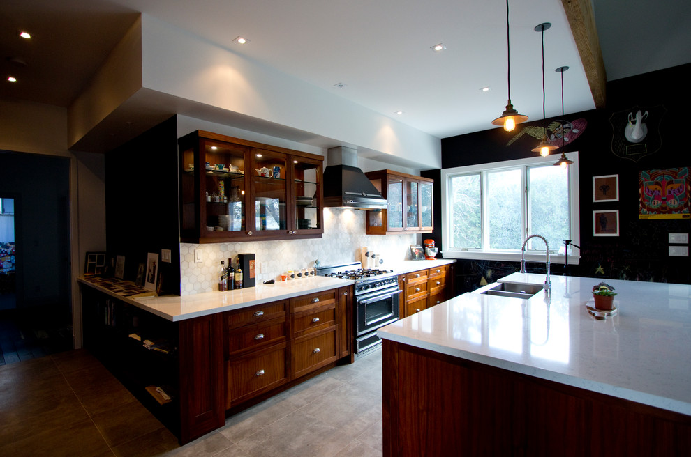 Photo of a large eclectic l-shaped open plan kitchen in Toronto with a farmhouse sink, shaker cabinets, medium wood cabinets, quartz benchtops, grey splashback, mosaic tile splashback, black appliances, porcelain floors and with island.