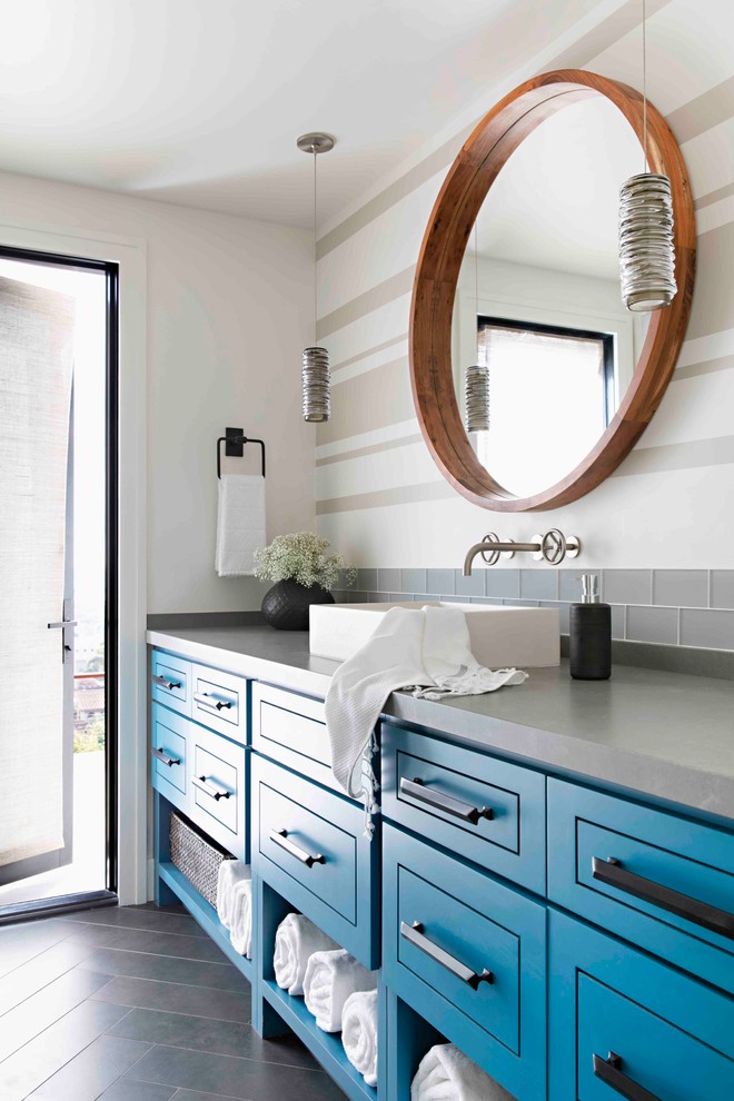 Inspiration for a mid-sized transitional bathroom in San Diego with turquoise cabinets, a corner shower, a one-piece toilet, gray tile, glass tile, white walls, ceramic floors, a vessel sink, quartzite benchtops, black floor, a hinged shower door and grey benchtops.