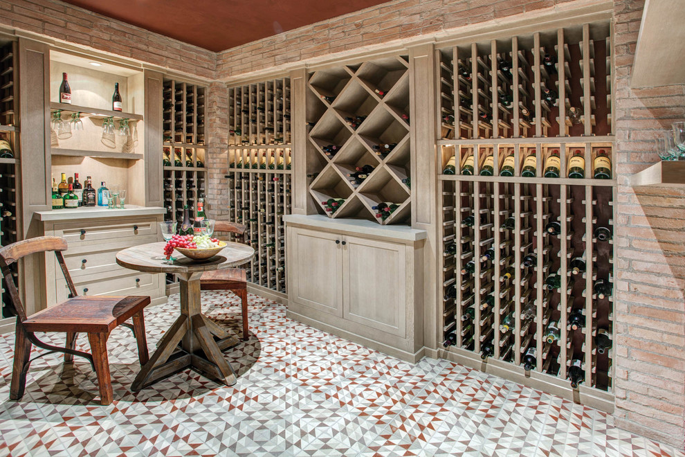 Photo of a mediterranean wine cellar in Los Angeles with storage racks and multi-coloured floor.
