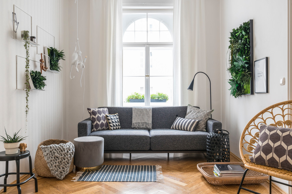 Design ideas for an expansive scandinavian formal enclosed living room in Munich with white walls, light hardwood floors, beige floor and no fireplace.