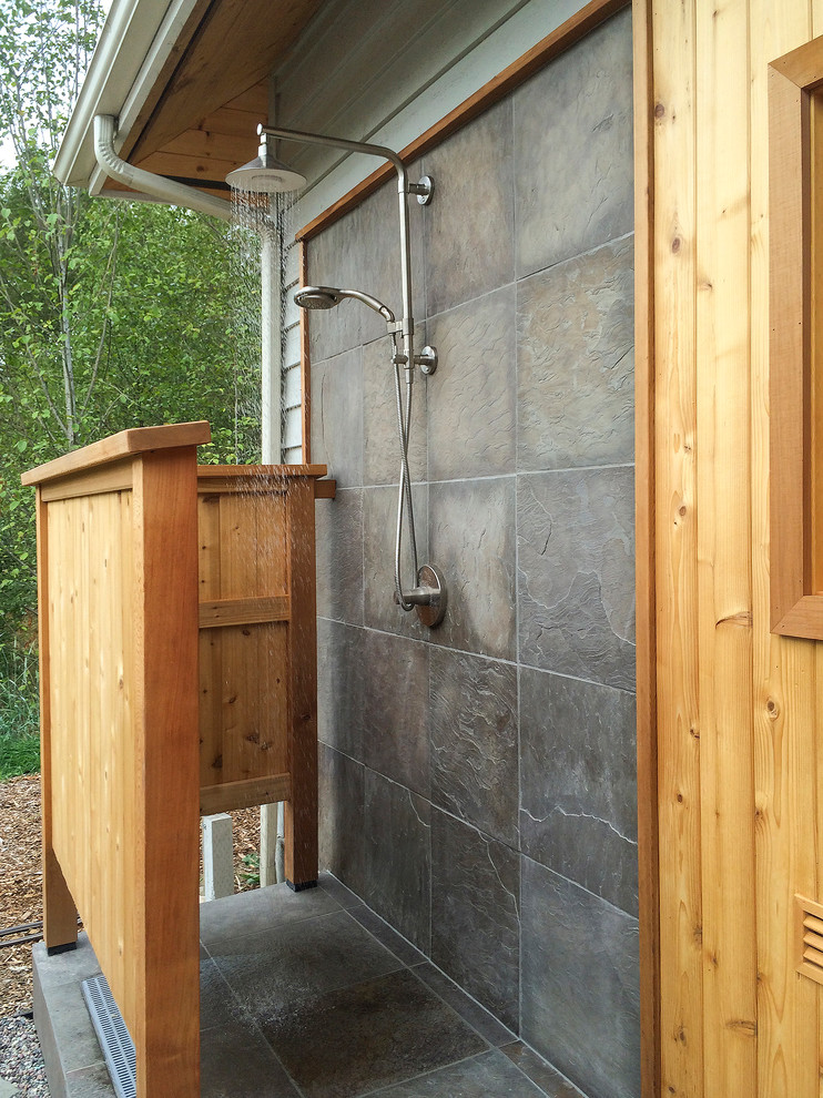 Photo of a mid-sized contemporary backyard patio in Seattle with an outdoor shower, gravel and a roof extension.