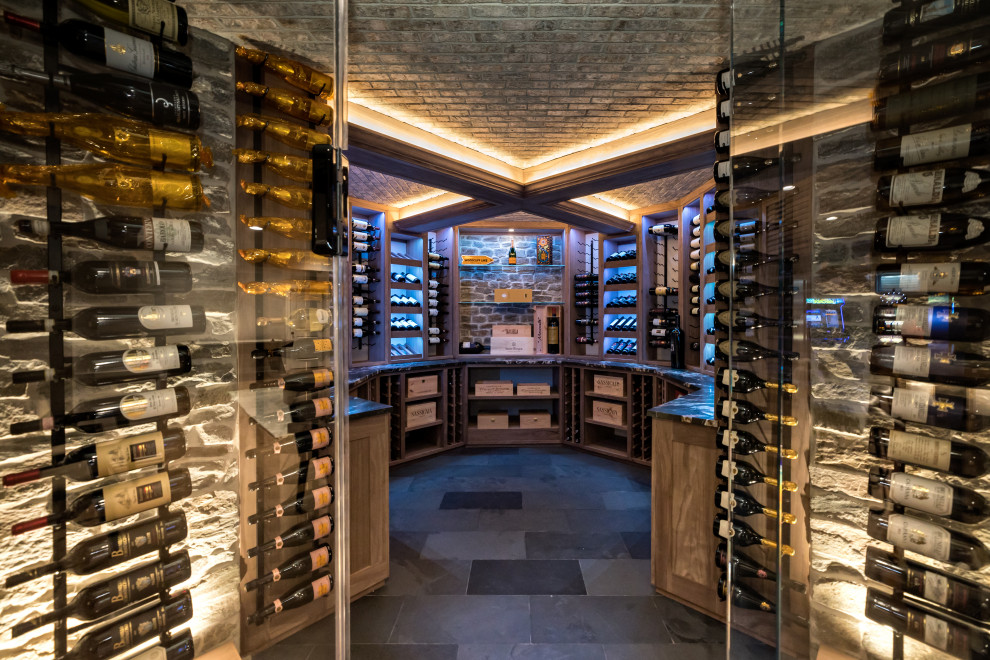 Inspiration for a large country wine cellar in New York with slate floors, display racks and black floor.