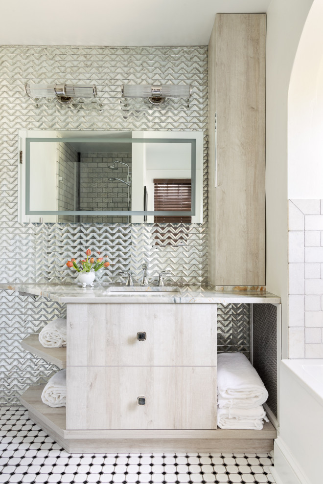 Design ideas for a medium sized bohemian bathroom in New York with flat-panel cabinets, light wood cabinets, a built-in bath, all types of toilet, multi-coloured tiles, mirror tiles, white walls, mosaic tile flooring, a submerged sink, marble worktops, white floors, beige worktops, a single sink, a built in vanity unit, all types of ceiling and all types of wall treatment.