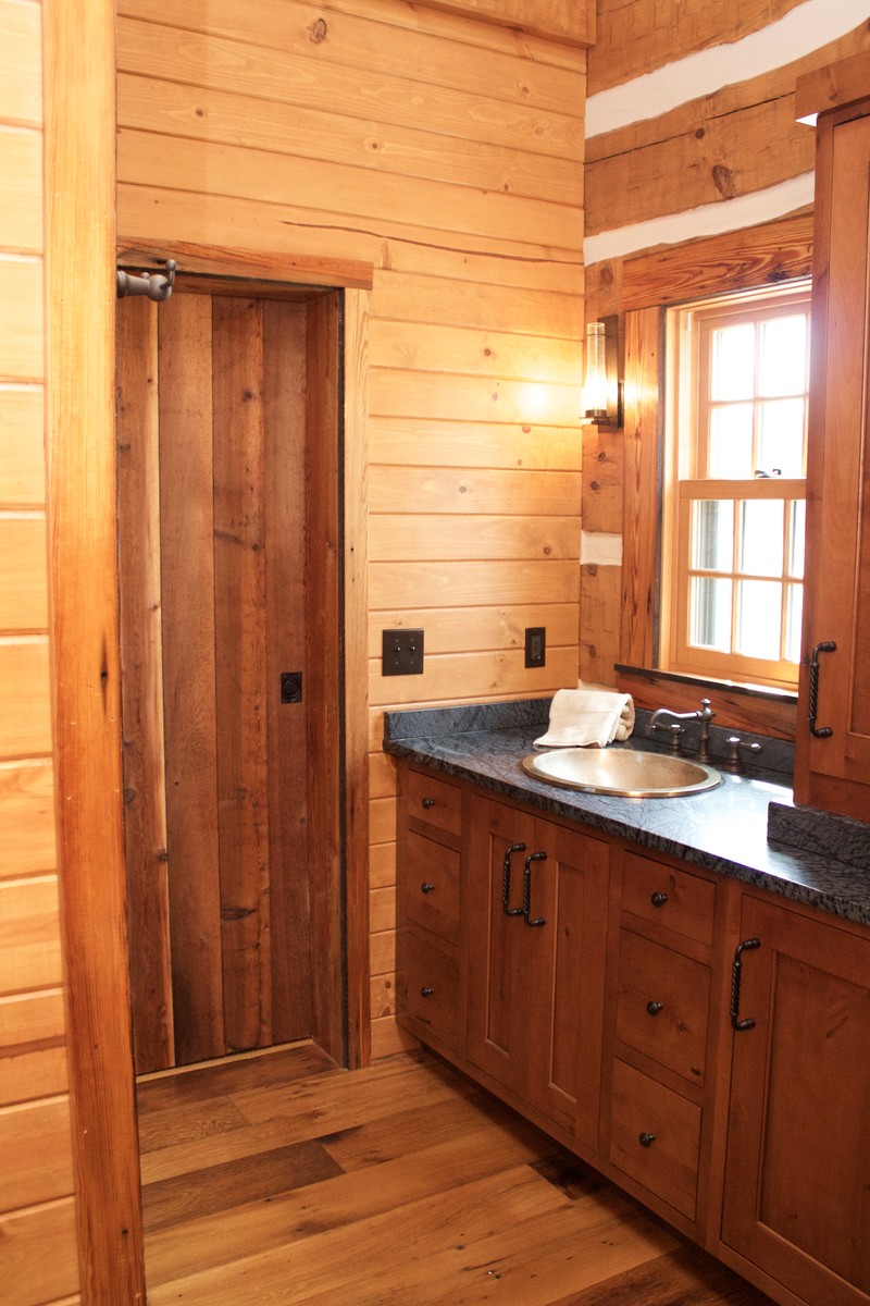 Small mountain style master bathroom photo with flat-panel cabinets and medium tone wood cabinets