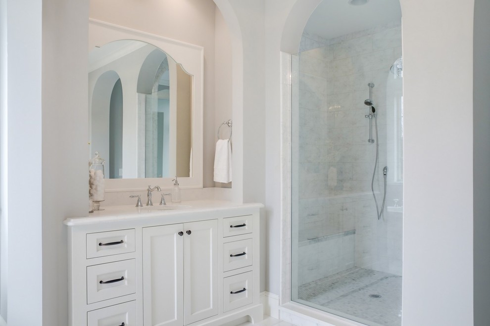 Inspiration for a large traditional master bathroom in Minneapolis with flat-panel cabinets, white cabinets, a freestanding tub, an alcove shower, white tile, ceramic tile, grey walls, ceramic floors, an undermount sink, quartzite benchtops, white floor and a hinged shower door.