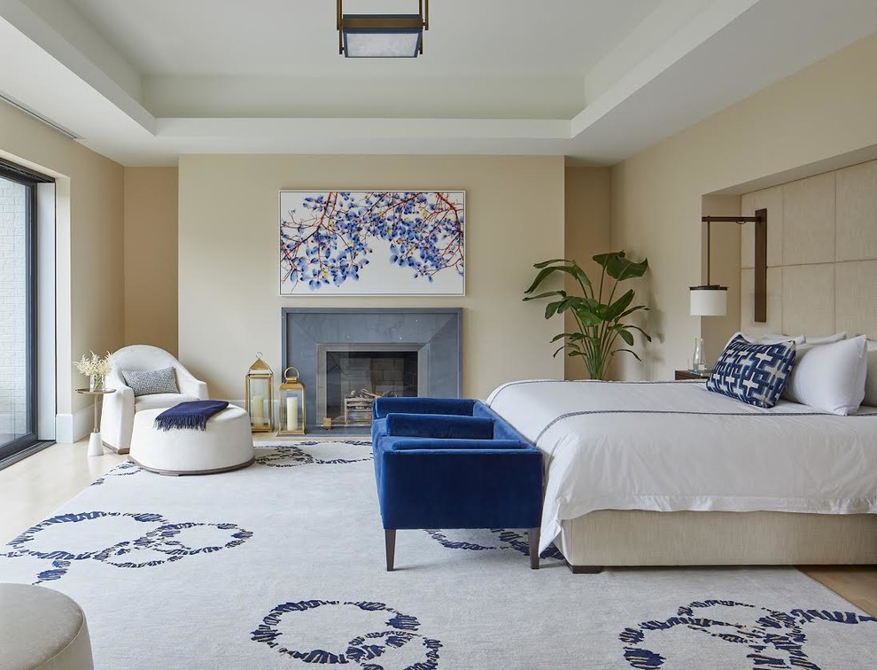 Design ideas for a large transitional master bedroom in DC Metro with beige walls, light hardwood floors, a standard fireplace, a concrete fireplace surround and beige floor.