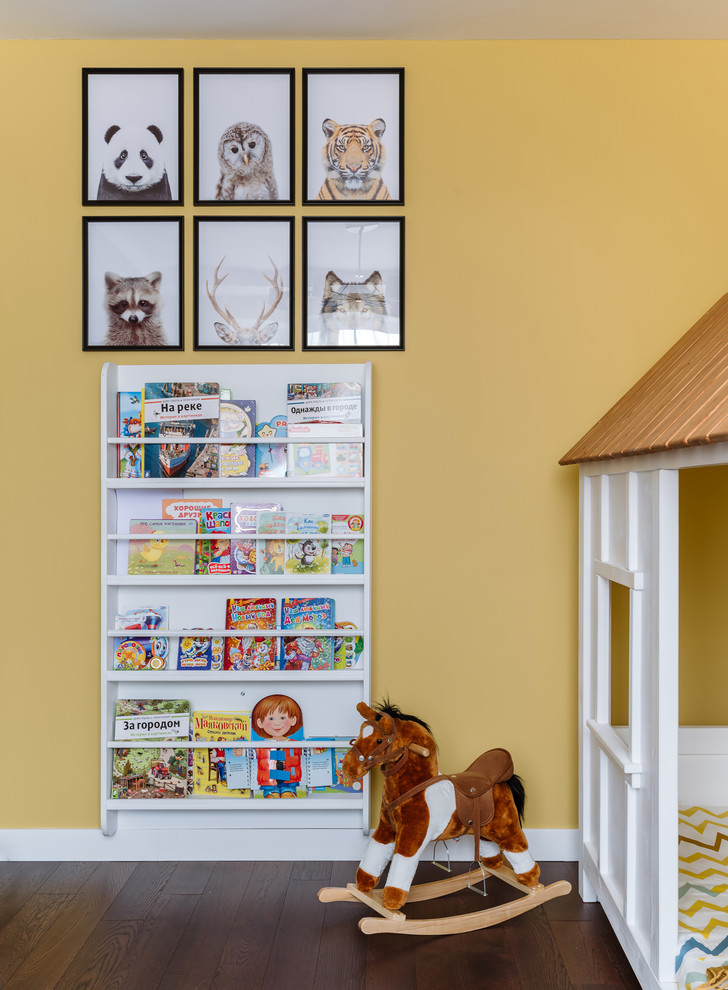 This is an example of a mid-sized contemporary nursery for boys in Moscow with multi-coloured walls, dark hardwood floors and brown floor.