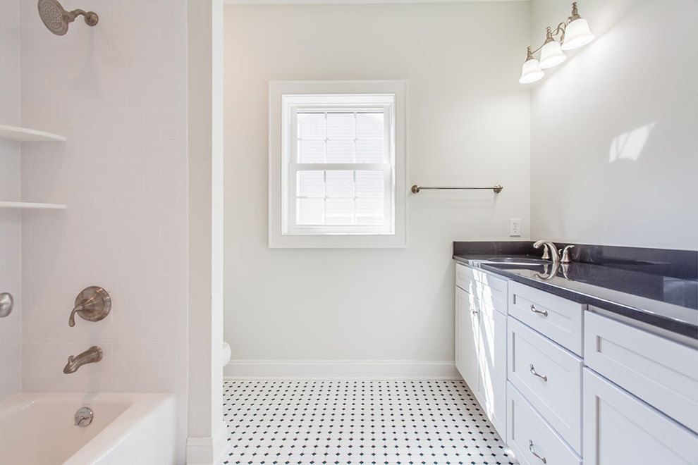 Inspiration for a mid-sized transitional 3/4 multicolored floor alcove bathtub remodel with shaker cabinets, white cabinets, white walls and an undermount sink